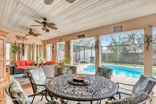 sunroom featuring ceiling fan