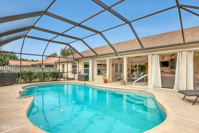 view of swimming pool with a lanai, a patio area, ceiling fan, and a grill