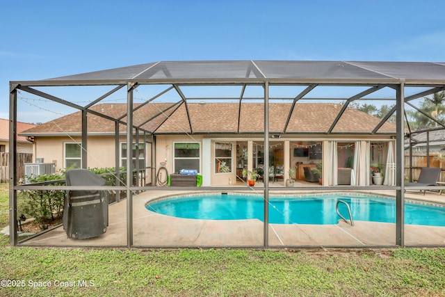 view of swimming pool featuring a lanai and a patio