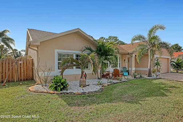 view of front of home with a front yard and a garage