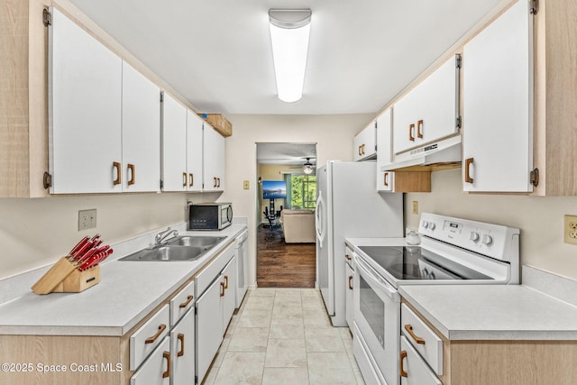 kitchen with white cabinets, electric stove, sink, and light tile patterned floors