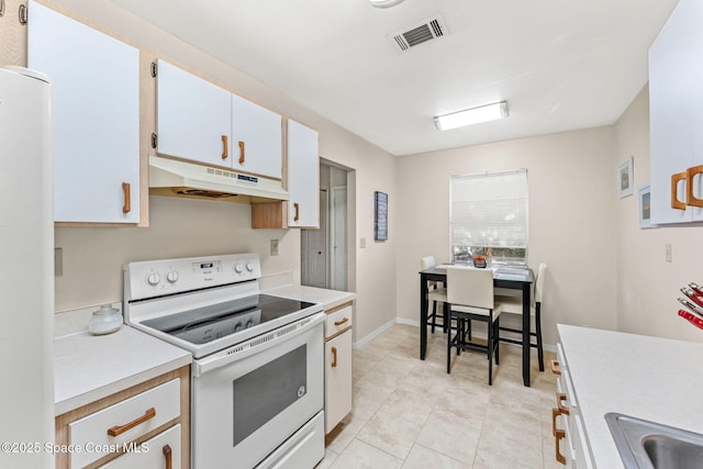 kitchen featuring sink, white cabinets, white appliances, and light tile patterned floors