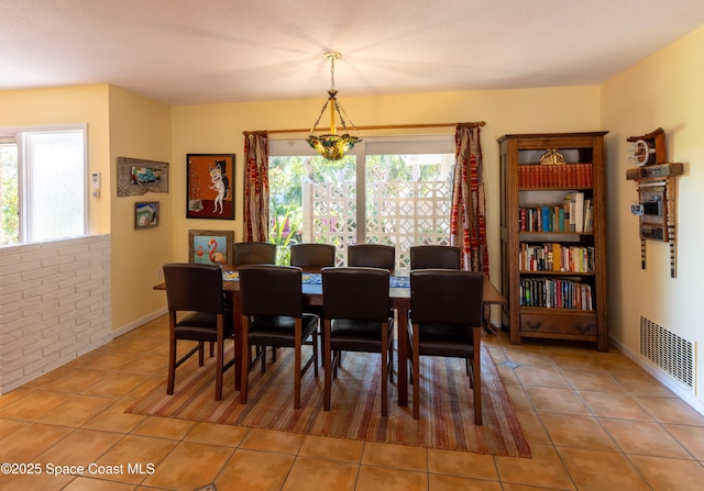 dining room featuring tile patterned flooring and visible vents