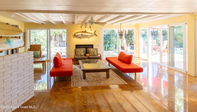 sunroom with a healthy amount of sunlight, a fireplace, and beam ceiling