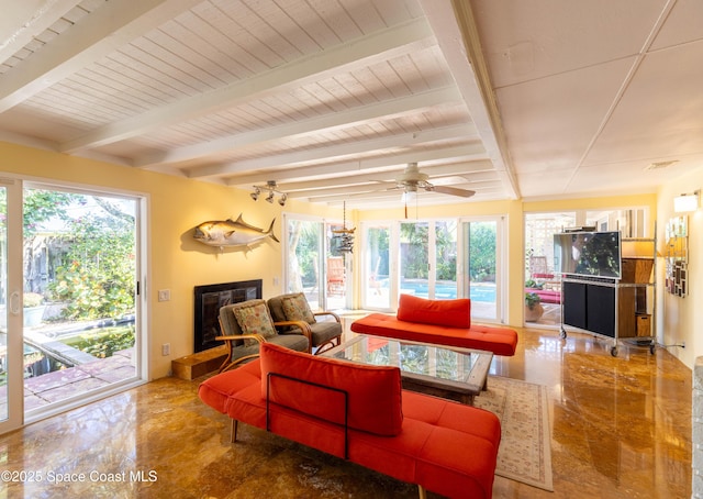 living area with a fireplace with raised hearth, marble finish floor, beam ceiling, and visible vents