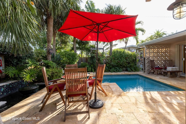 view of swimming pool with a patio area, fence, and a fenced in pool