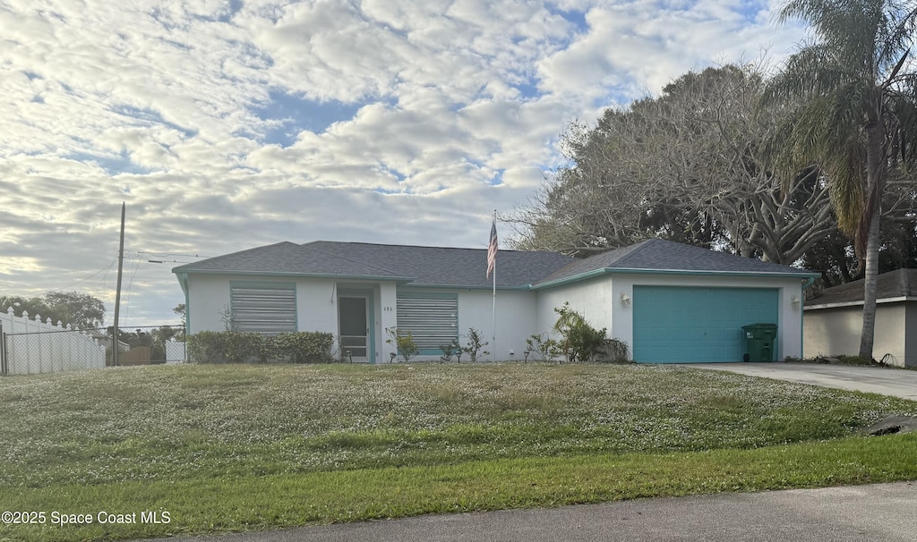 single story home featuring a front yard and a garage