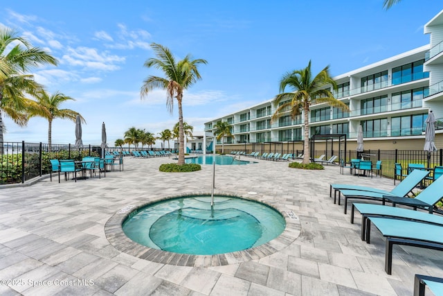 view of swimming pool featuring a patio and a community hot tub