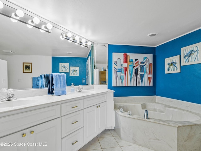 bathroom with a washtub, vanity, and tile patterned flooring