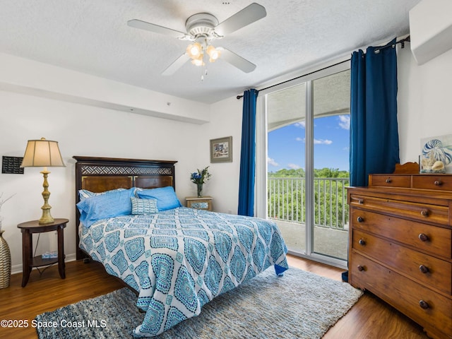 bedroom featuring access to exterior, ceiling fan, a textured ceiling, and hardwood / wood-style flooring