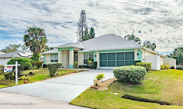 ranch-style home with a front lawn and a garage