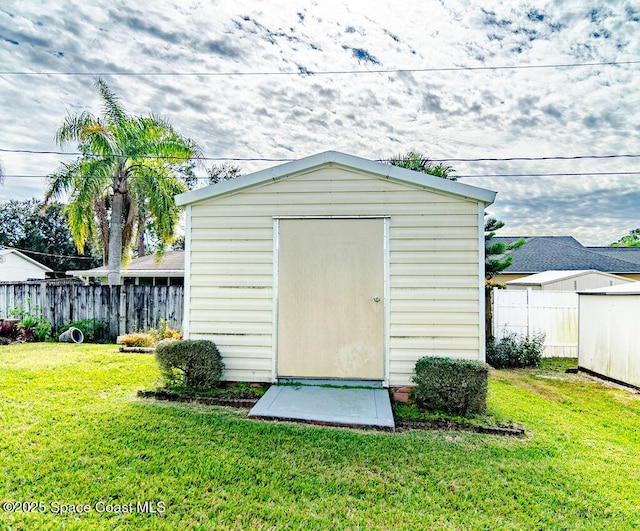 view of outdoor structure with a lawn