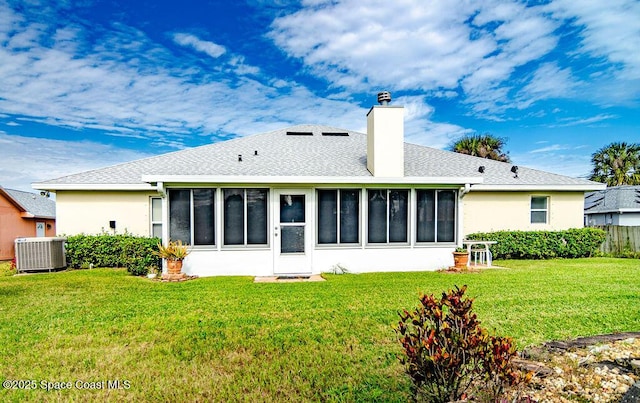 back of property featuring cooling unit, a yard, and a sunroom