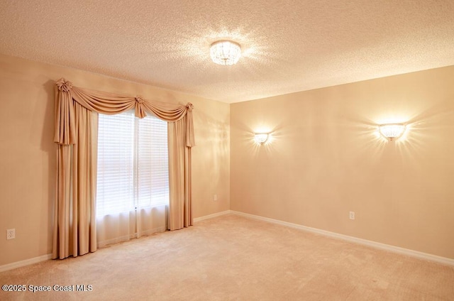 carpeted spare room with a textured ceiling