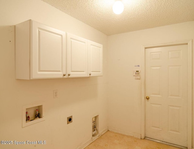 clothes washing area with hookup for a washing machine, cabinets, hookup for an electric dryer, and a textured ceiling