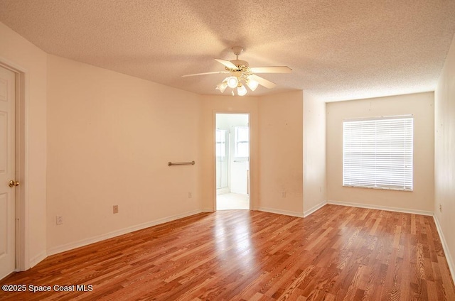 spare room featuring ceiling fan, a textured ceiling, and hardwood / wood-style flooring