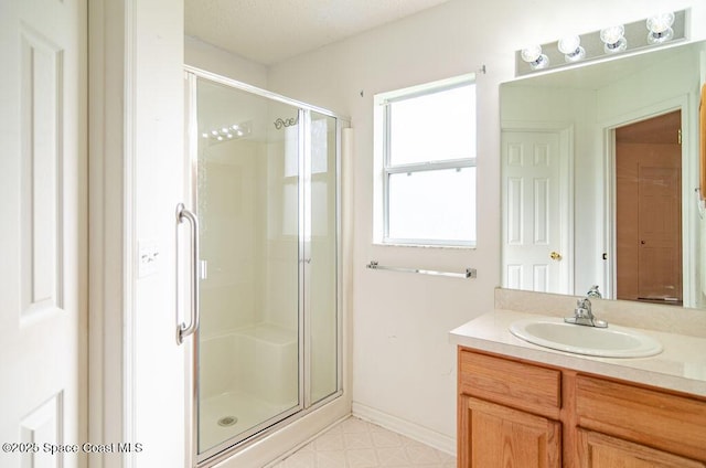 bathroom with walk in shower and vanity