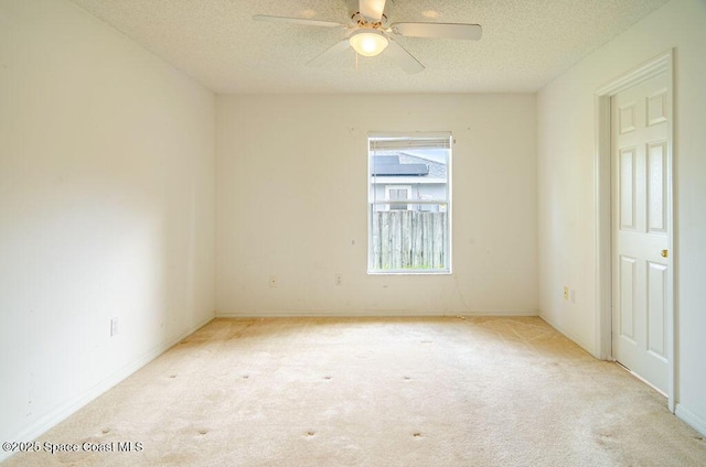 carpeted empty room with a textured ceiling and ceiling fan