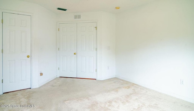 unfurnished bedroom with light colored carpet