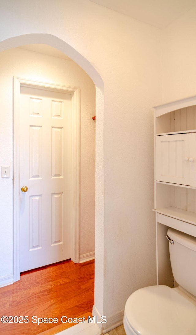 bathroom featuring toilet and hardwood / wood-style floors