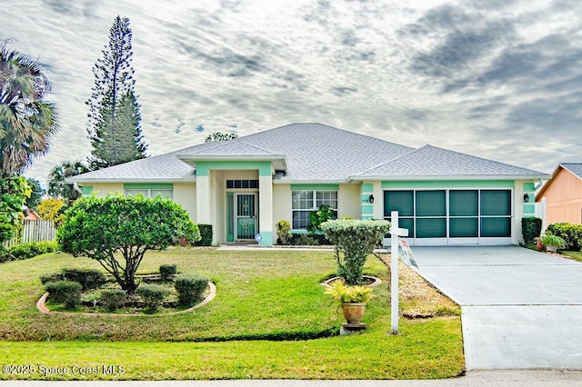 view of front of house featuring a front yard and a garage