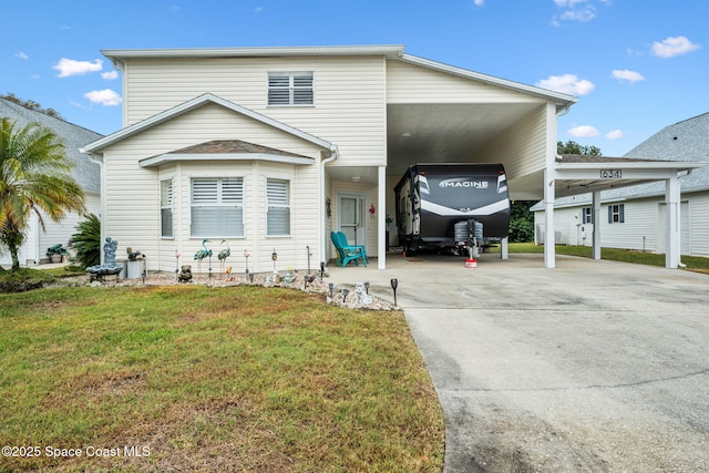 view of property featuring a front lawn and a carport