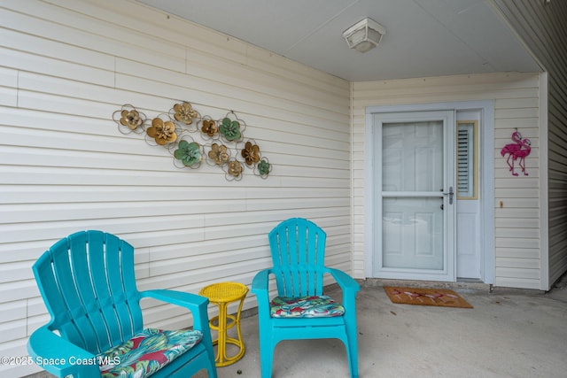 view of exterior entry featuring a patio area