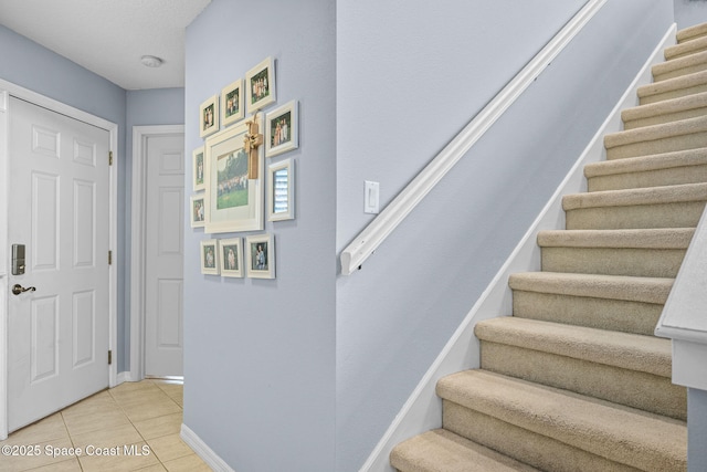 stairway with tile patterned flooring