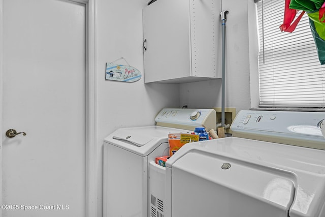 laundry area with cabinets and independent washer and dryer