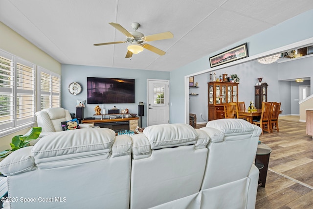 living room featuring ceiling fan and light wood-type flooring