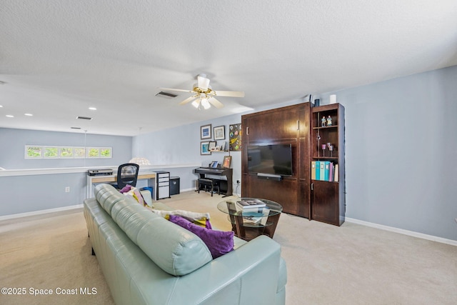 carpeted living room with ceiling fan and a textured ceiling