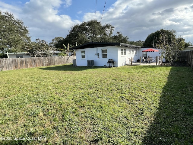 view of yard featuring a patio and central air condition unit