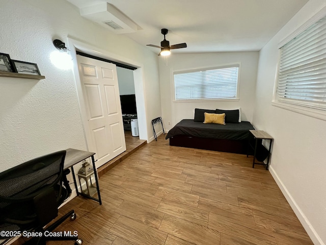 bedroom with a barn door, vaulted ceiling, and ceiling fan