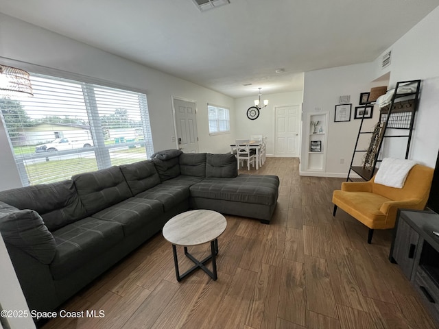 living room featuring a chandelier and dark hardwood / wood-style floors