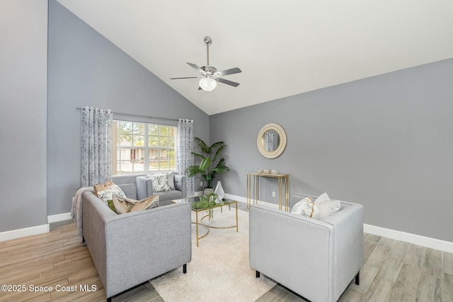 living room with high vaulted ceiling, ceiling fan, and light hardwood / wood-style flooring