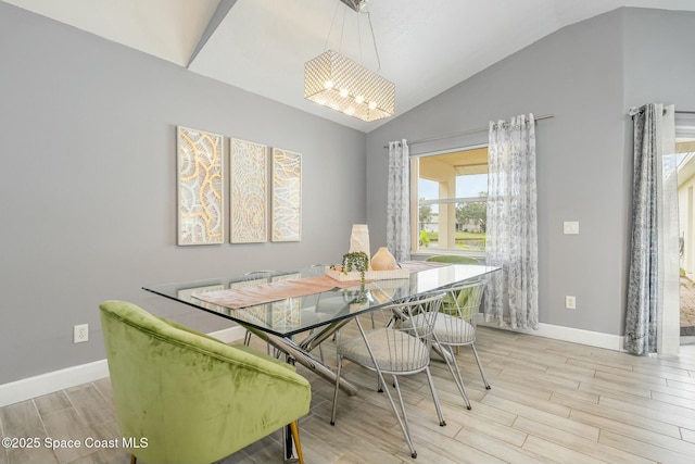 dining area featuring vaulted ceiling and light hardwood / wood-style flooring