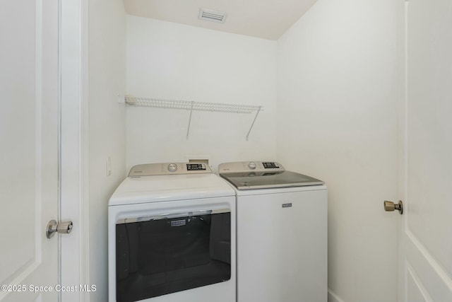 laundry room with washing machine and clothes dryer