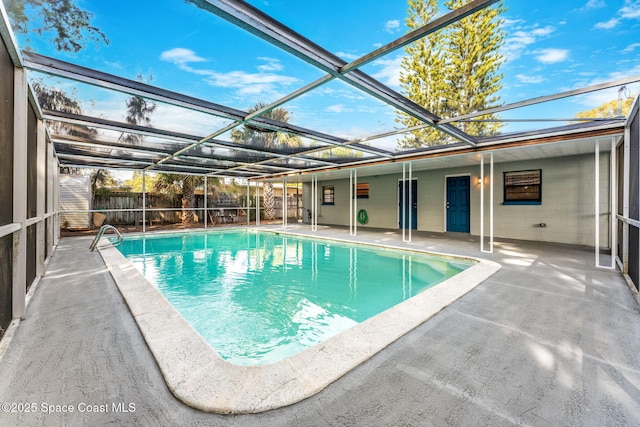 view of pool with a patio and glass enclosure