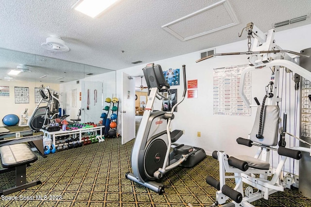 gym with a textured ceiling