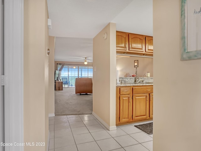 hallway featuring light tile patterned flooring