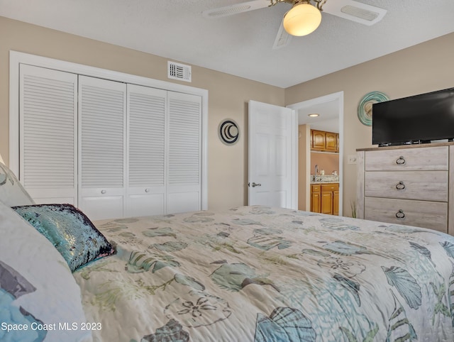 bedroom with ceiling fan and a closet