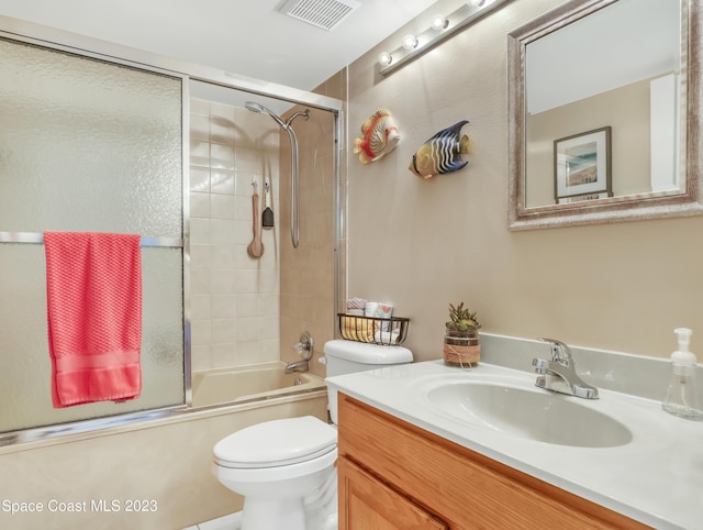 full bathroom with vanity, toilet, and bath / shower combo with glass door