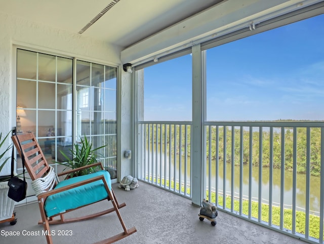 sunroom / solarium with a water view