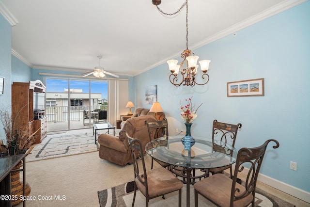 dining room featuring carpet floors, ornamental molding, and ceiling fan with notable chandelier