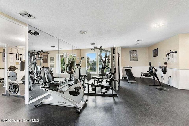 gym with a textured ceiling