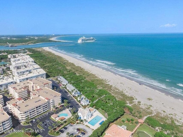 aerial view with a water view and a beach view