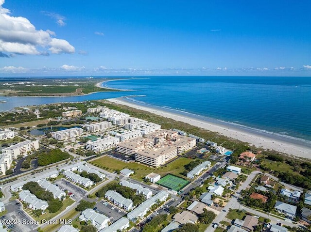 drone / aerial view featuring a water view and a view of the beach