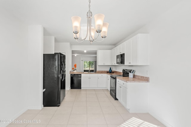 kitchen featuring pendant lighting, white cabinets, black appliances, an inviting chandelier, and light tile patterned floors