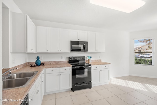 kitchen with sink, white cabinetry, black appliances, and light tile patterned flooring