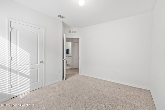 unfurnished bedroom featuring light carpet